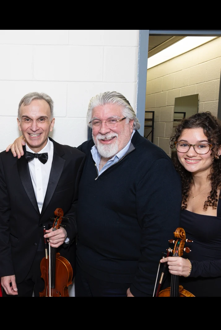 Victoria backstage with fellow violinists in formal concert attire