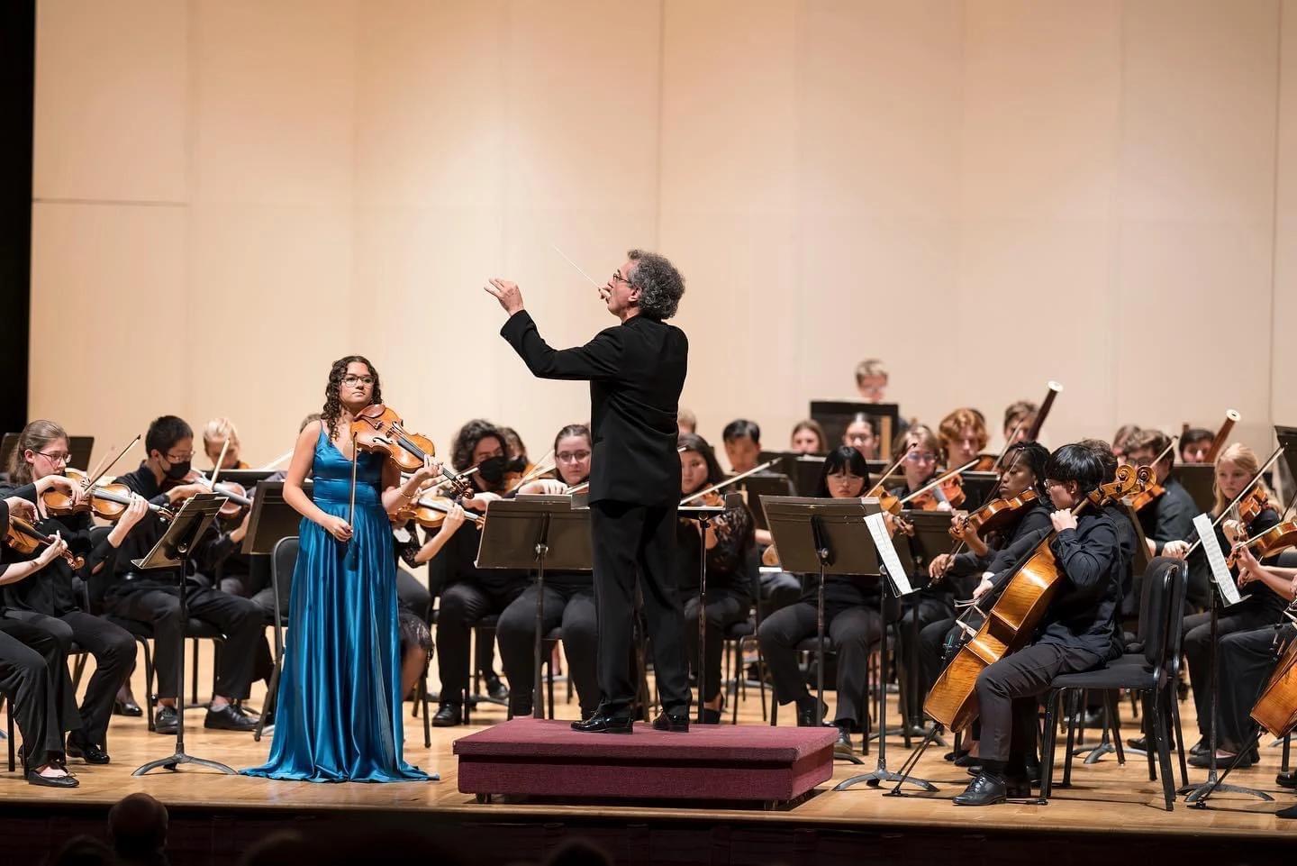 Victoria performing as a soloist in front of a full orchestra